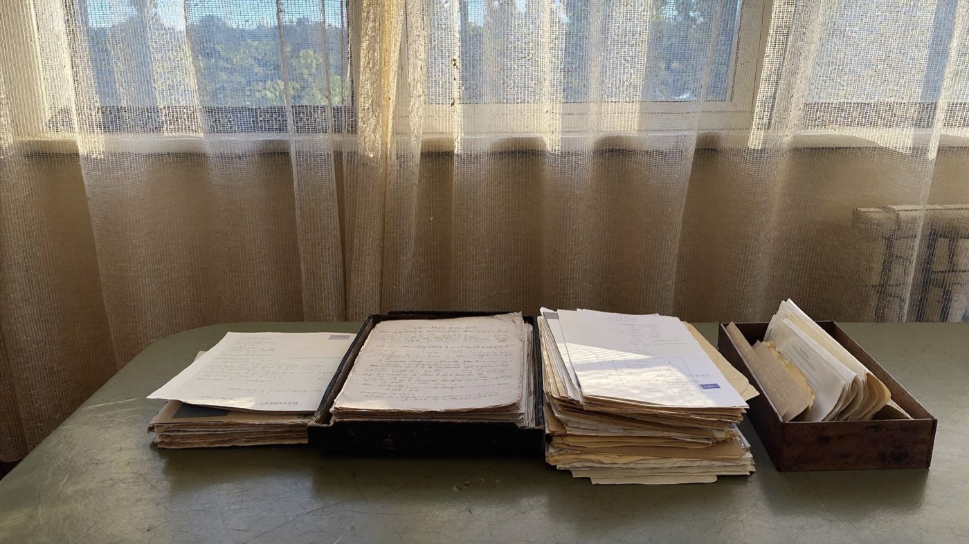 Household papers and an old document box on a dining table